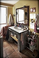Detail of the sink and mirror in the bathroom with the accessories of daily use 