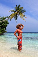 Girl watching the Ocean at the seashore, Biyadhoo island, Maldives