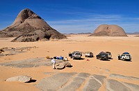 tourists and huge granite mountains at Tehenadou, Immidir, Algeria, Sahara, North Africa