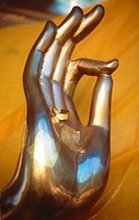 Brass Buddha hand with gold leaf applied to palm, Vitarka mudra intellectual argument, wheel of law, Thailand