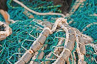 Pacific herring purse seine net and lead line on stack on fishing boat in Sitka, Alaska.