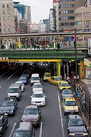 The JR Chuo line train platform at Iidabashi Station sits above the traffic on Mejiro-dori Avenue, Chiyoda Ward, Tokyo, Japan