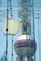 Detail of Apple logo in store with Pearl Oriental Tower to rear in Shanghai China