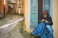 Mural of a woman in a wall of Orgosolo, Sardinia, Italy