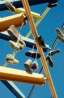Shoes hanging of a sculpture in Valencia, Spain