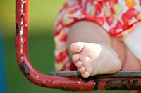 Close up of a toddler foot on a swing