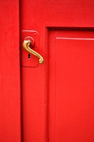 red door with curved brass handle - shot straight on