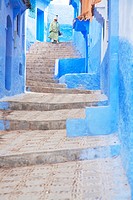 Woman down the stairs in Chaouen