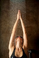 woman taking a shower under water jet
