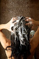 woman washing her hair under shower water