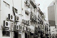 A back street scene showing the air conditioning units in use in the restaurants and bars of central Singapore in Southeast Asia Far East.