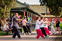 Chinese people practice tai chi martial arts exercise early morning at the Temple of Heaven Park during summer in Beijing, China