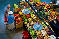 A couple shopping at an indoor market for fresh fruit and vegetables, Ontario, Canada