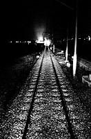 The headlights of a night train in the distance
