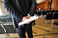 STOCKHOLM SWEDEN Businessman holding a plastic folder and document behind his back