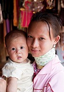 Woman from the Kayan minority group with her baby, Huai Seau Tao, Mae Hong Son Province, Thailand