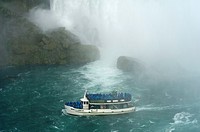 Maid of the Mist boat carrying tourists at the bottom of Niagara Falls
