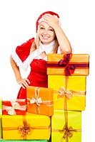 Young beautiful blond happy smiling woman in Santa costume surrounded by Christmas gift boxes, isolated on white background