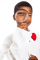 Happy clever scientist school boy with magnifying glass, isolated on white background