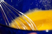 Beating eggs  Beating 6 eggs using a whisk in a blue glass bowl  The eggs should be beated vigorously to add air on the mixture   The well beaten egg ...