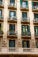 Façade decorated with borders overloaded with 3 faces of men that looking at street Constructed in 1935 Mallorca street nº 352, Barcelona The rest of ...