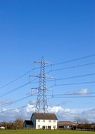 Electricity tower and detached house in rural area