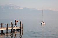 Man Fishing on Lake Geneva at Ouchy, Lausanne, Switzerland, Europe
