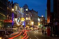 Shaftesbury Avenue theatre district, West End, London, England, with car light streaks, dusk