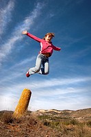 Girl jumping in the blue sky