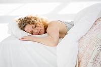 Attractive young woman sleeping in her bed