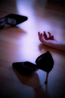 Lifeless body and high heeled shoes at a murder scene