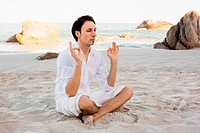 Man Meditating on Beach