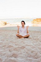 Man Meditating on Beach