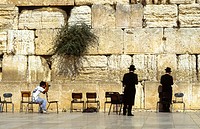 Two praying jews at the Wall at Jerusalem being photographed