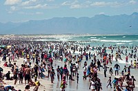 Crowds op people flock to the beach on a warm summer's day. New Year's Day. Cape Town, South Africa