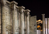 Corinthian columns of the west wall ruins of the Hadrian's Library in the Roman Agora and Acropolis in the background, Athens, Greece.