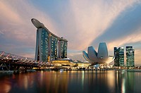 Marina Bay Sands hotel at sunset with the ArtScience museum designed by the architect Moshe Safdie, the helix bridge on the left. Singapore, Marina Ba...