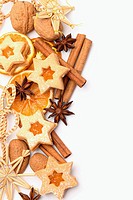 Dry orange slices, spices and Christmas cookies on white background.