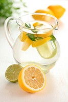 Jug of fresh lemon lemonade with mint leaves.