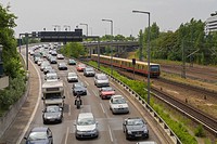 Traffic jam at city motorway ""Stadtautobahn"" on a car free Sunday, a commuter local train ""S-Bahn"" bypass the traffic jam, Charlottenburg-Wilmersd...