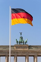 Brandenburg Gate with Quadriga and German national flag, Mitte district, Berlin, Germany, Europe.