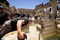 Middle-aged man cooling in the fountain gate of Jaen Baeza, Fountain of the lions in the Plaza of Pópulo also called the Lions square, Baeza, Jaén Pro...