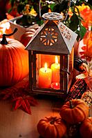 Lantern with candles, pumpkins and autumn decorations.