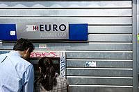 rear view of two people in a Euro ATM automatic cash, paris, France, Europe
