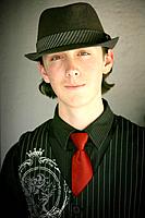 Teenager in fedora hat and red tie