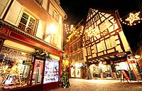 Typical timber-framing houses witn Christmas lights at the city center by night. Colmar. Wine route. Haut-Rhin. Alsace. France.