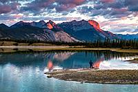 Photographer watching the sunrise over the Canadian Rocky Mountains in the Jasper National Park, Alberta, Canada