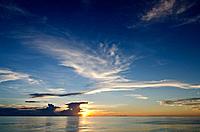 Cumulus and cirrus cloud patterns at sunset, South Pacific ocean.