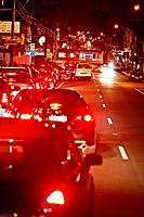 Traffic congestion at railway crossing, red tail lights of cars, Melbourne Australia