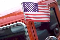 American flag blowing in the Ford.